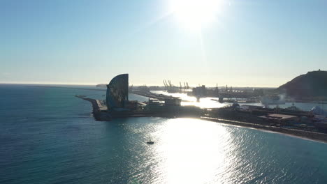 Luxury-hotel-in-Barcelona-with-giant-port-in-background-aerial-view-sunny-day